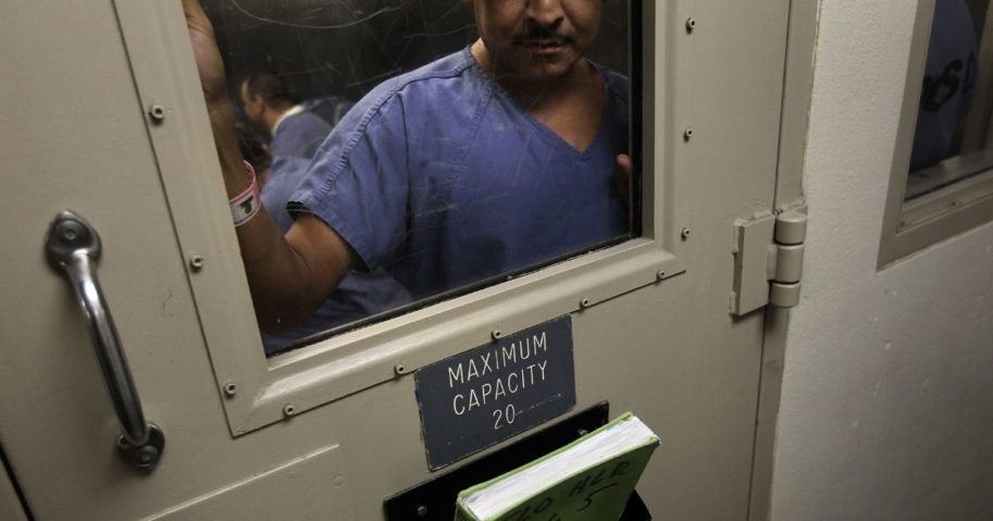 A man stands in a holding cell at the U.S. Immigration and Customs Enforcement detention facility for illegal immigrants in Florence, Arizona, on July 30, 2010. (John Moore / Getty Images)